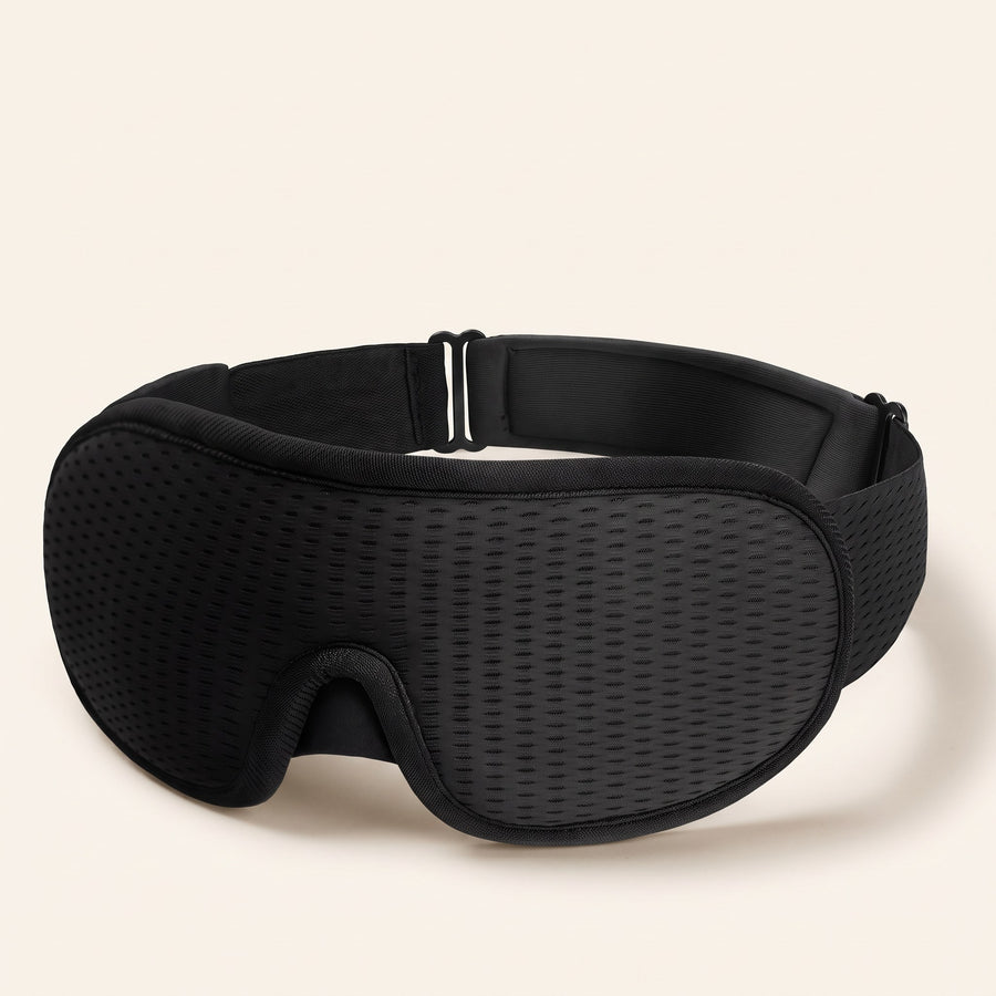 3D blackout sleep mask on a plain background