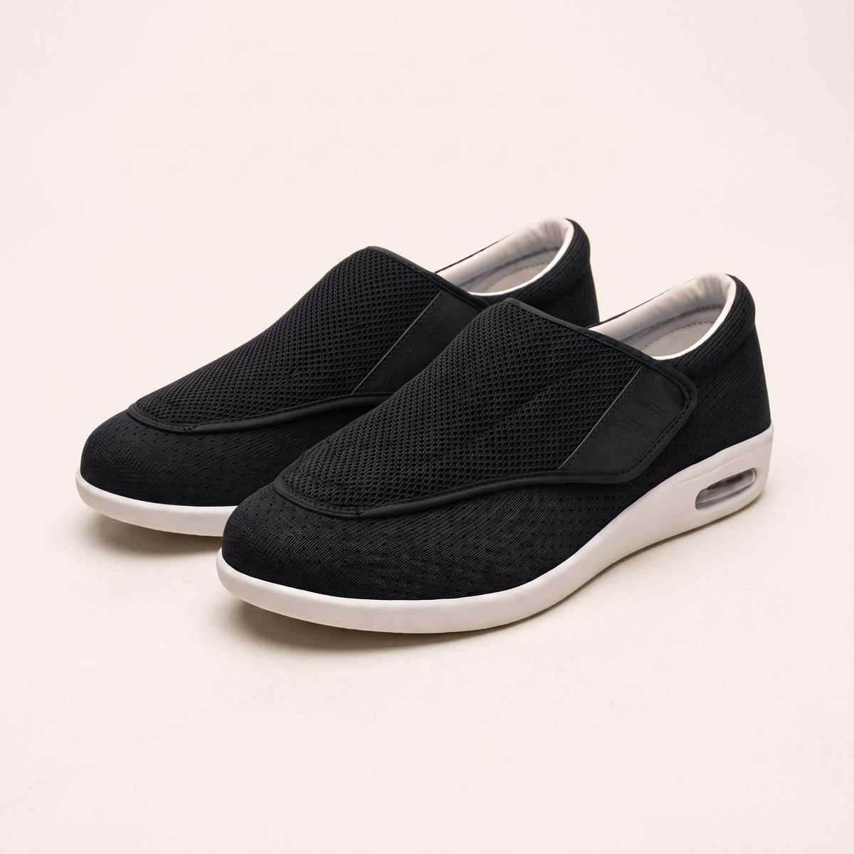 Wide-fit diabetic shoes with hook-and-loop strap on a plain background