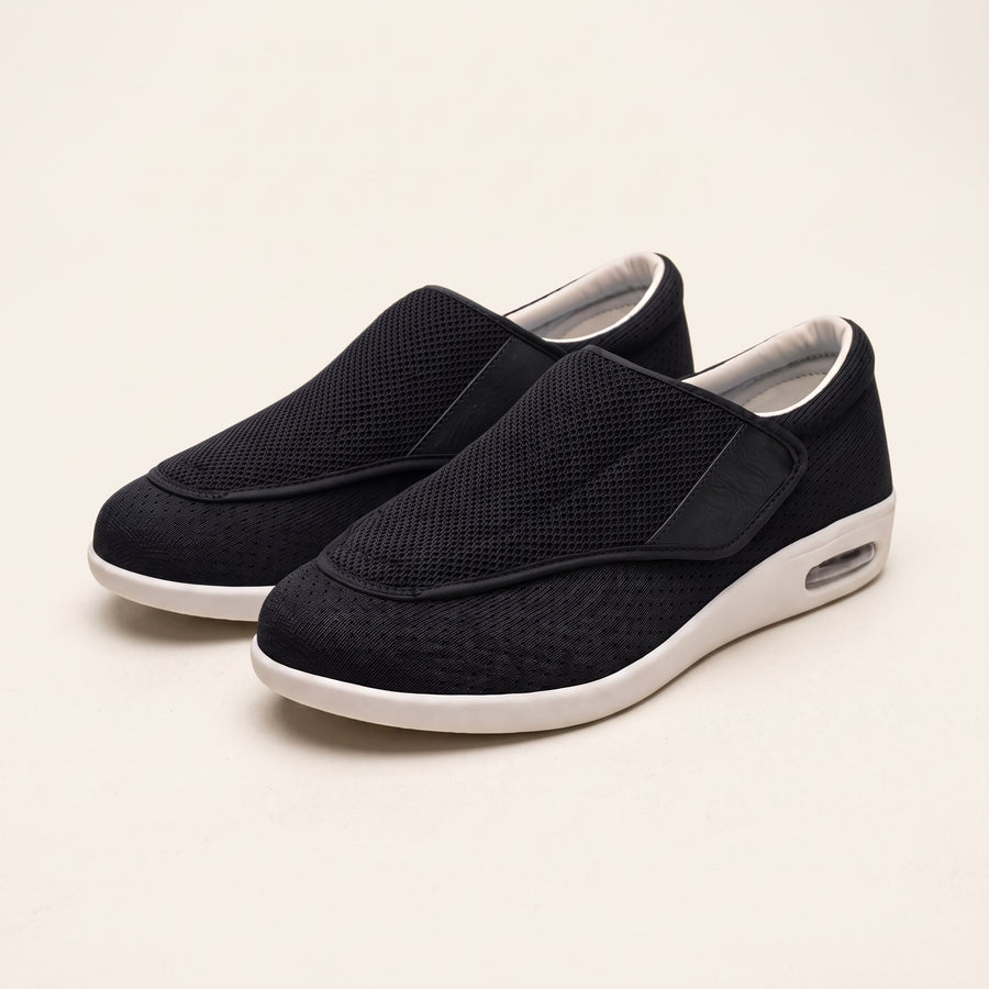 Wide-fit diabetic shoes with hook-and-loop strap on a plain background