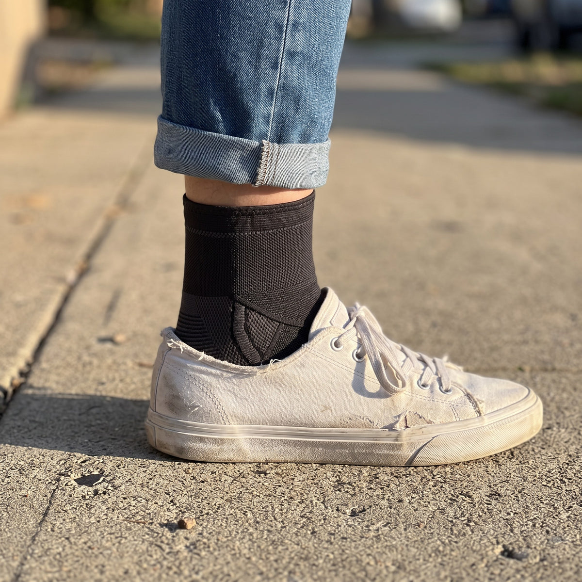 Strydex Foot Sleeve worn under rolled jeans with a white canvas sneaker