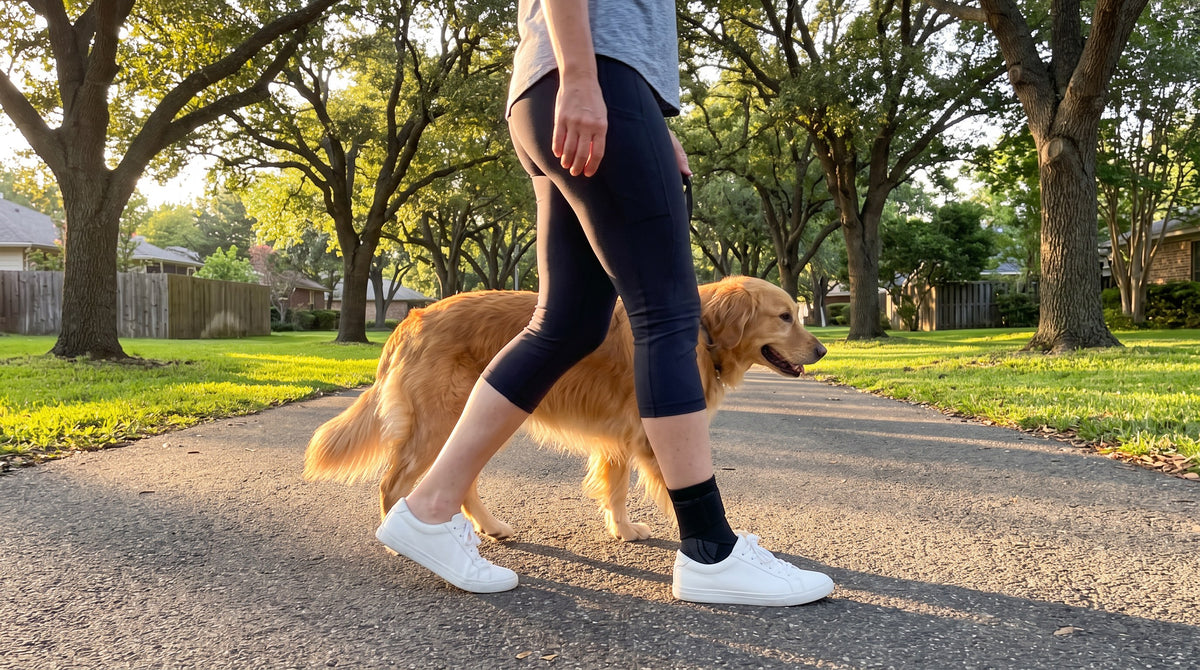 Woman walking her dog in the park wearing the Strydex Foot Sleeve